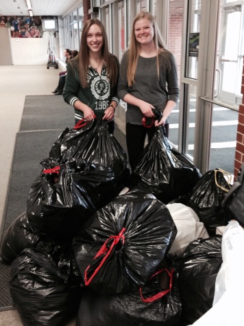 Seniors Madi Sogge and Brenna Steichen helping with the coat drive.